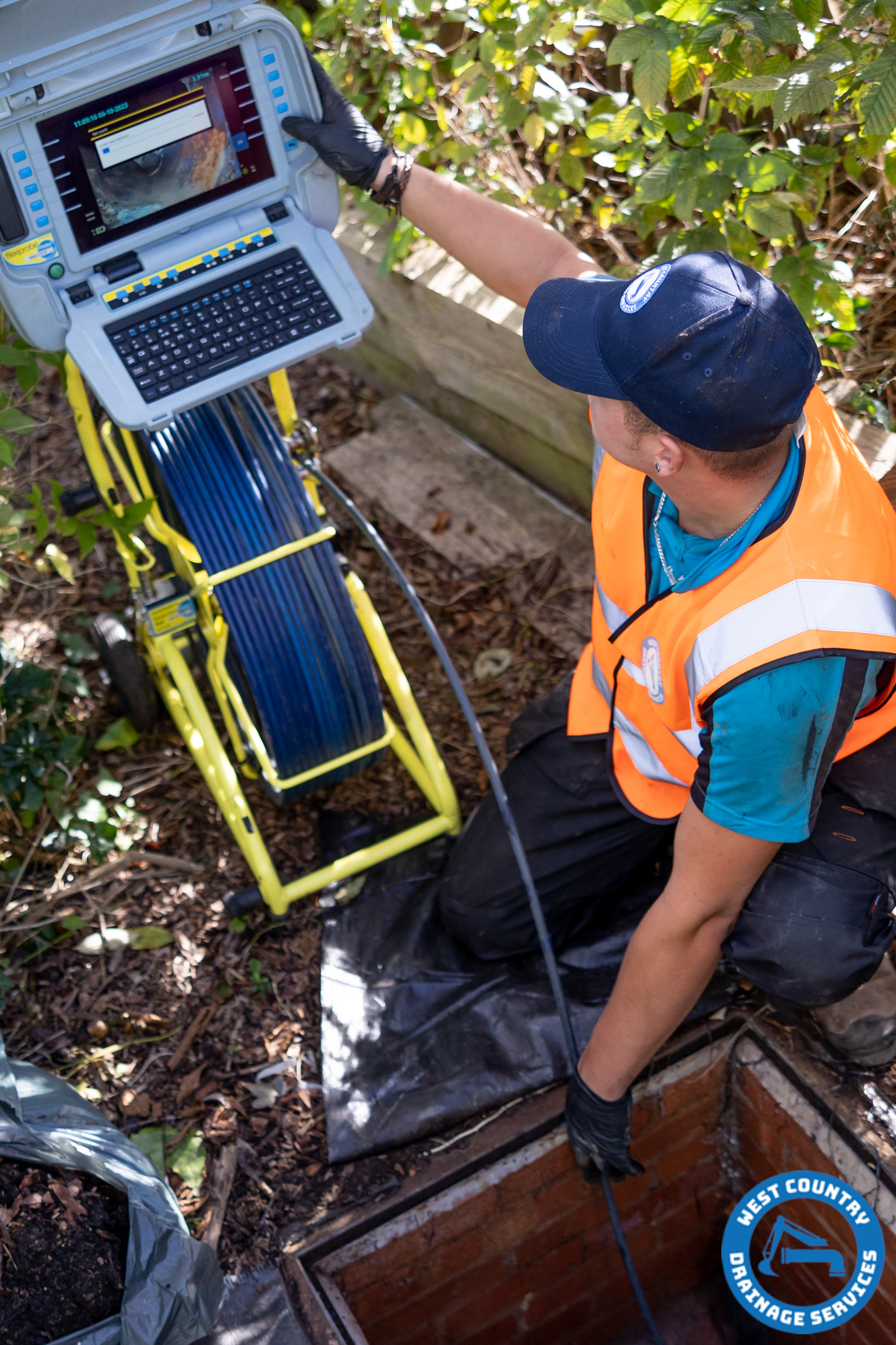 West Country Drainage Services member of the team inspecting a drain ready to have a new liner installed.